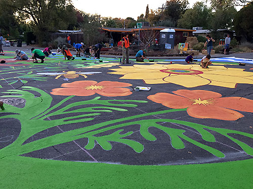 Large, bright poppies and a sunflower add fun to the street mural.