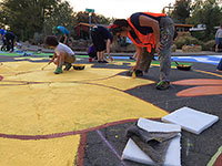 Danielle Fodor adds another coat of yellow paint to the sunflower.