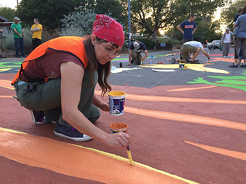 Jenn, one of the Creative Cats, adds detail to the oak tree trunk. 