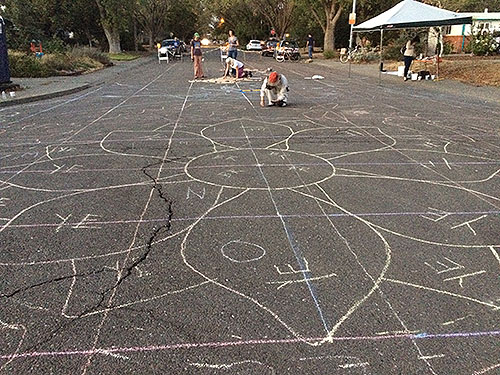 While tracing stencils, a giant sunflower awaits bright paint.